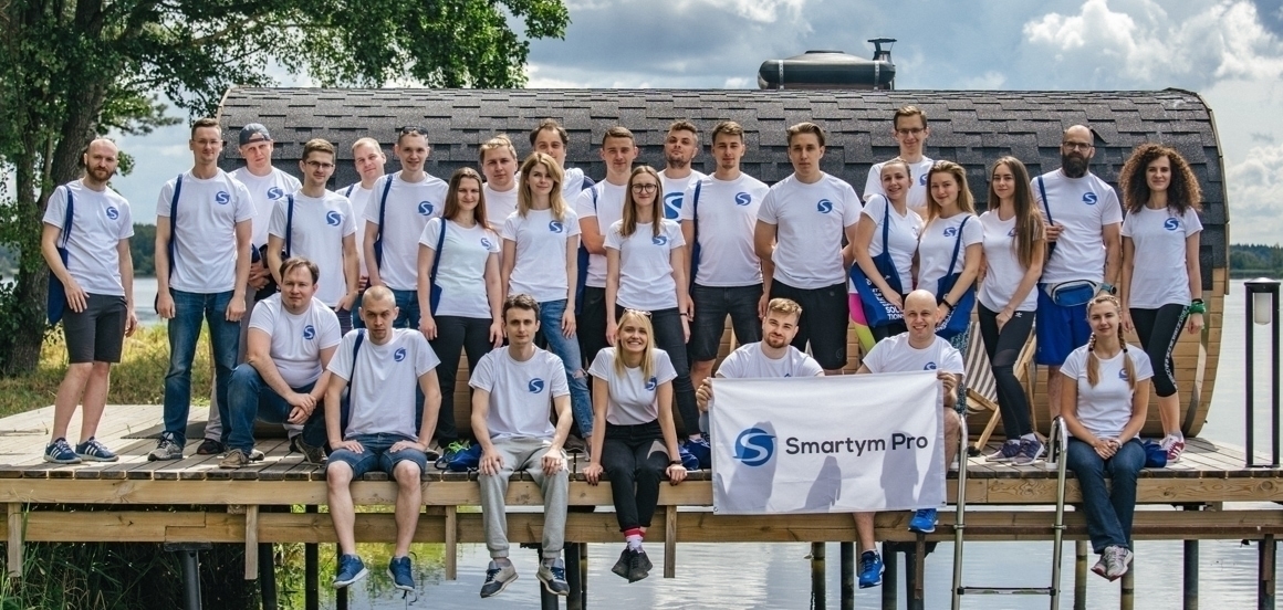 Team of Smartym. People in white t-shirts with logo of Smartym.